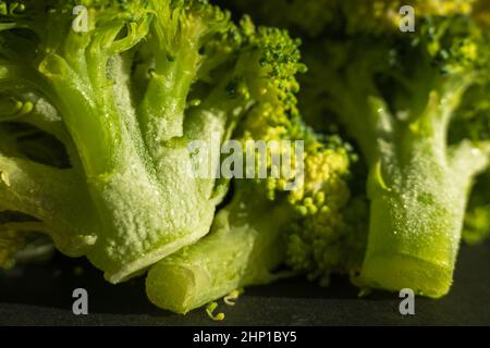 Broccoli verdi congelati su fondo scuro closup Foto Stock