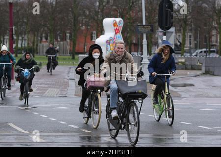 Amsterdam, Paesi Bassi. 18th Feb 2022. I ciclisti lottano contro gli alti venti attraversare la strada il 18 febbraio 2022 ad Amsterdam, Paesi Bassi. L'ufficio meteorologico olandese KNMI ha emesso un avviso meteorologico in codice rosso per la costa e arancione per il resto del paese, i trasporti pubblici, i servizi ferroviari internazionali e più di 165 voli dall'aeroporto di Schiphol sono stati cancellati dal 2pm. (Foto di Paulo Amorim/Sipa USA) Credit: Sipa USA/Alamy Live News Foto Stock