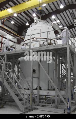 La capsula del drago di Space Exploration Technologies Corp. (SpaceX) è posta sopra il relativo anello di carico all'interno di un hangar di lavorazione alla stazione dell'aeronautica di Cape Canaveral in Florida il novembre 16. In seguito, la combinazione sarà attaccata alla parte superiore di un razzo Falcon 9 su Space Launch Complex-40 per il prossimo volo dimostrativo della società per il programma Commercial Orbital Transportation Services (COTS) della NASA ca. 2011 Foto Stock