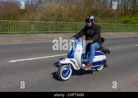 Lambretta stile anni '1962 60 148 cc benzina; motociclista; trasporto a due ruote, motocicli, veicolo italiano, Strade, motociclette, motociclisti che guidano a Chorley, Regno Unito Foto Stock