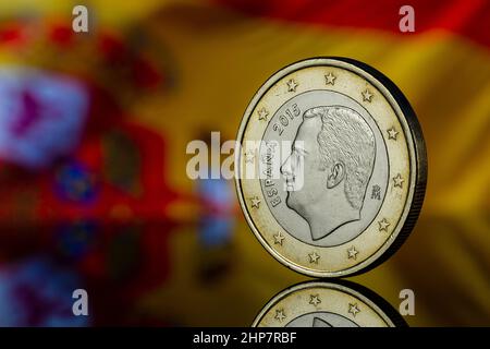 Philip Felipe VI Re di Spagna Euro Coin con Spagna Bandiera sfocata nello sfondo riflesso Copia spazio Foto Stock