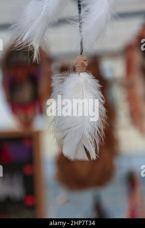 Piuma bianca in un catcher da sogno appeso al soffitto. Foto Stock