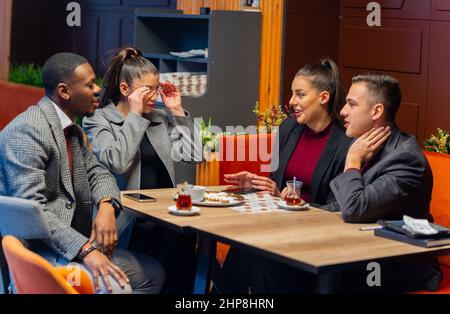 Gruppo di gente di busniess multirazziale sta ridendo insieme mentre parla Foto Stock