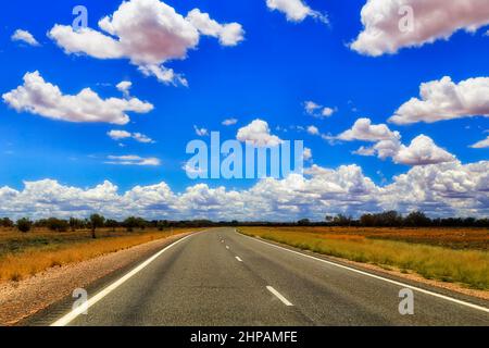 L'autostrada remota vuota di Silver City nell'entroterra australiano - pianure e cespuglii infiniti. Foto Stock