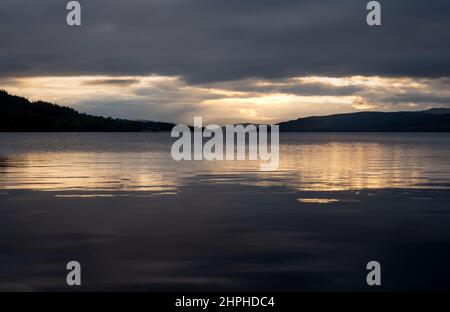 Una vista lungo la lunghezza di Loch Rannoch dalla costa orientale al tramonto, verso Stob na Cruaiche, Rannoch, Scozia, Regno Unito Foto Stock