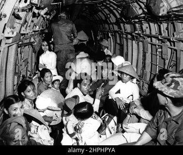 Sbalordito dalla vivacità di un attacco Viet Cong al loro villaggio, i rifugiati della guerra del Vietnam cavalcano un elicottero dell'Aeronautica militare in un'area sicura vicino Saigon. Marzo 1966. CA. Marzo 1966 Foto Stock