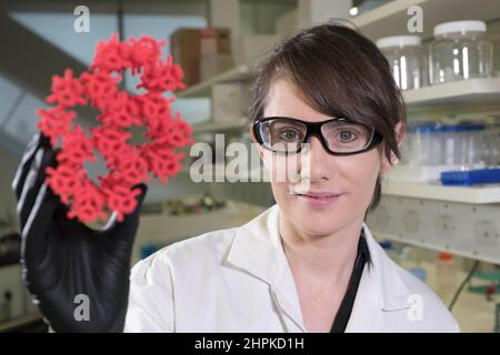 (220222) -- CANBERRA, 22 febbraio 2022 (Xinhua) -- Foto fornita dall'Australia's Commonwealth Scientific and Industrial Research Organization (CSIRO) il 22 febbraio 2022 dimostra che la scienziata senior del CSIRO Cara Doherty mostra un modello del materiale dei quadri organici metallici (MOF). I ricercatori dell'agenzia scientifica nazionale australiana hanno sviluppato una tecnologia che potrebbe eliminare la necessità di refrigerare i vaccini. In uno studio pubblicato martedì, il team della Commonwealth Scientific and Industrial Research Organization (CSIRO) ha scoperto che incapsulando i vaccini con virus vivi in una struttura metallica organica Foto Stock