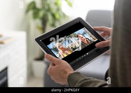 Comunicazione remota del lavoro. Businesswoman Holding Tablet avere un incontro online con il gruppo di colleghi fare videochiamata tramite computer seduto in moderno Foto Stock