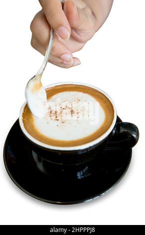 Vista dall'alto della mano e una tazza di caffè cappuccino, selezione della messa a fuoco Foto Stock