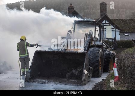 Un vigile del fuoco del servizio antincendio e di soccorso di Hereford & Worcester che utilizza schiuma per estinguere un digger JCB in fiamme a Moccas, Herefordshire, Regno Unito Foto Stock