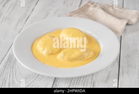 Quenelle - miscela di pesce cremato con salsa di Hollandaise Foto Stock