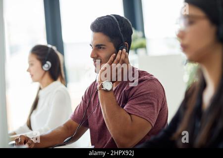 Ha le migliori capacità di comunicazione. Immagine di un gruppo di rappresentanti del servizio clienti che lavorano alla scrivania. Foto Stock