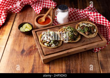 Tacos de Suadero. Carne fritta in una tortilla di mais. Street food di CDMX, Messico, tradizionalmente accompagnato da coriandolo, cipolla e salsa rossa piccante Foto Stock