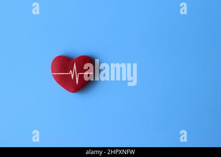 Vista dall'alto dell'immagine del cuore rosso e della linea del battito cardiaco su sfondo blu con spazio di copia per il testo. Foto Stock