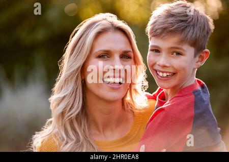 Testa e spalle Ritratto di Madre e Figlio sorridenti che abbraccia all'aperto Foto Stock