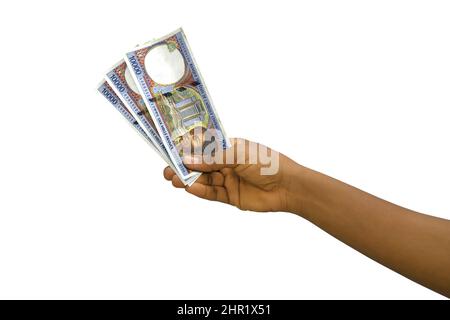 Fair Hand Holding 3D rese note di franco CFA centrafricano isolate su sfondo bianco Foto Stock