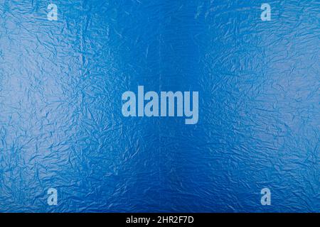 fondo piatto full frame e tessuto di pellicola di plastica blu grattata Foto Stock