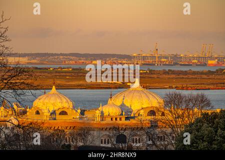 Guardando verso il porto di Thames Gateway con le cupole del Guru Nanak Darbar Gurdwara a Gravesend in primo piano al tramonto Foto Stock