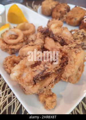 Delizioso pesce calamaro fritto marinato, tipico cibo andaluso. Tapas spagnole calamari o calamares racion Foto Stock