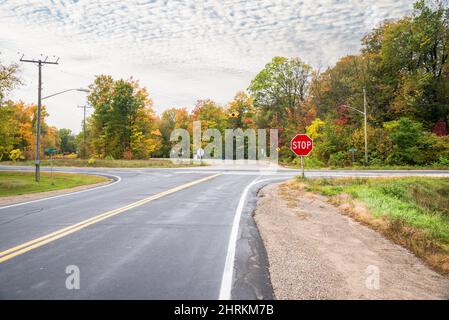 Crocevia pericolosa in campagna in una nuvolosa giornata autunnale. Colori autunnali sullo sfondo. Foto Stock