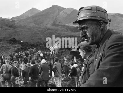 I soccorritori prendono una pausa dalla ricerca a seguito del catastrofico crollo di una punta in collirio nel villaggio gallese di Aberfan, vicino a Merthyr Tydfil, il 21 ottobre 1966. La frana risultante di 40.000 metri cubici di liquame di carbone ha inghiottito il villaggio e Pantglas Junior School uccidendo 116 bambini e 28 adulti. È stato causato da un accumulo di acqua nella roccia e scisto sulla punta locale dello spolio collirio, che improvvisamente ha iniziato a scivolare in discesa sotto forma di slurry.The eventi di Venerdì, 21 ottobre 1966 Tip no 7, che era 500 piedi sopra il villaggio di Aberfan, vicino a Merthyr Tydfil, sta Foto Stock