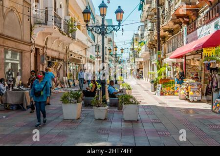 Authentic street shot of people and colonial buildings in El Conde street in the Colonial Zone. Stock Photo