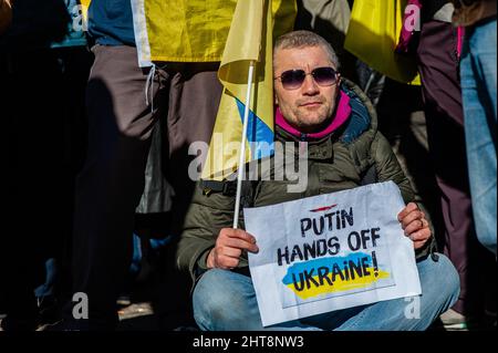 Amsterdam, Paesi Bassi. 27th Feb 2022. Un manifestante ucraino tiene un cartello durante una protesta anti-guerra contro l'invasione russa dell'Ucraina.la comunità Ucraina, la comunità russa e diverse organizzazioni non governative nei Paesi Bassi, accompagnate da migliaia di persone si sono riunite in piazza Dam per protestare contro Putin e l'invasione russa dell'Ucraina. Credit: SOPA Images Limited/Alamy Live News Foto Stock