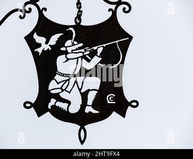 Colmar, Francia - 13 dicembre 2021: Rilievo di un cacciatore di uccelli sulla piastra di metallo di un ristorante a Colmar Foto Stock