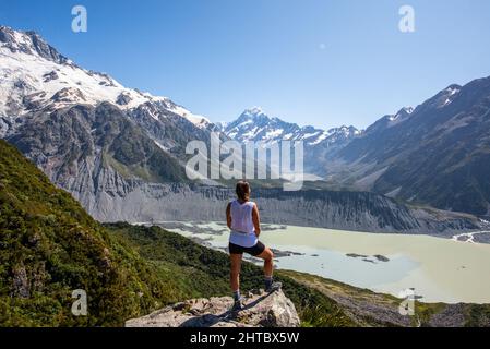 Caucasian woman looking to the distance at Hooker valley leading to Aoraki Mount Cook in New Zealand Stock Photo