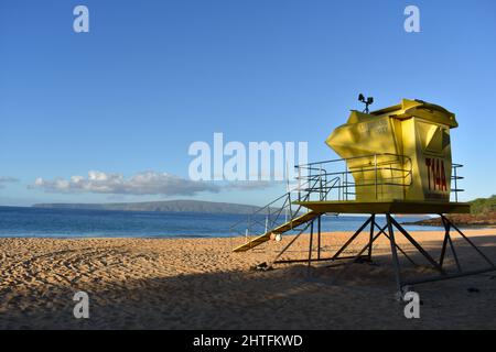 Torre gialla di bagnino contro un cielo blu su una spiaggia di sabbia a Maui, Hawaii Foto Stock