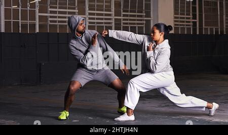 Tutti erano combattimenti kung-fu. Un giovane uomo e una donna che si allenano nella lotta. Foto Stock