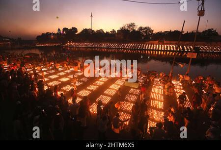 Ujjain, India. 01st Mar 2022. I devoti illuminano le lampade sulle rive del fiume santo Kshipra per stabilire un nuovo record mondiale di illuminazione 2,1million lampade in occasione del festival Maha Shivratri. Il governo dello Stato di Madhya Pradesh sta cercando di creare un nuovo record nel Guinness Book illuminando 2,1 milioni di lampade in terra nella città Santa infrangendo il record precedente di 9, 45.600 lampade ad Ayodhya in occasione di Diwali. Credit: SOPA Images Limited/Alamy Live News Foto Stock