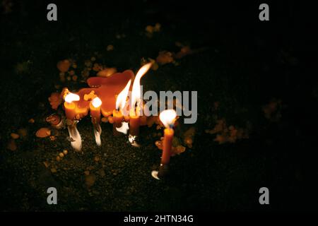 Candele sciolte al buio . Candele nella chiesa Foto Stock