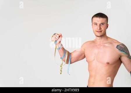 Uomo con pesi salute ponderato, salute e sport su uno sfondo bianco schiena ferita ferita, mal di schiena uomo salute medicina, tenuta. Tensione Foto Stock