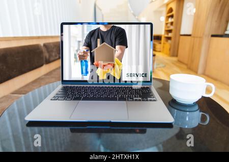 servizio di pulizia della casa su laptop servizio di pulizia. Contattare il servizio di pulizia professionale online Foto Stock