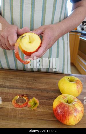 Cucina sveva, preparazione frittelle di mele, buccia mela, frutta per dessert, dessert, Dessert, mani degli uomini, coltello, Germania Foto Stock