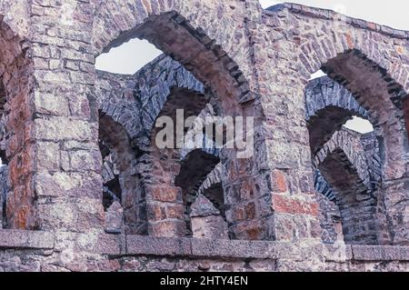 Archi in pietra curvi all'interno delle rovine del forte Golconda, una cittadella fortificata costruita nel 16 il secolo dalla dinastia Qutb Shani. Foto Stock