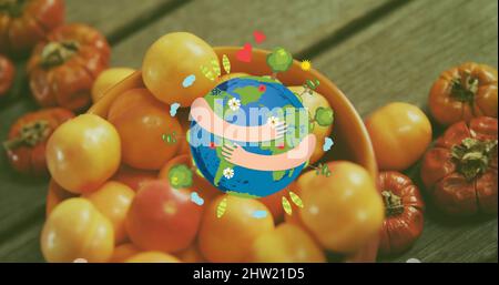 Immagine di braccia avvolte intorno al pianeta terra su pomodori freschi Foto Stock