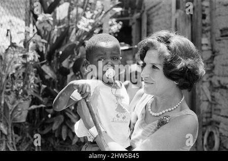 Rio de Janeiro, Brasile, 24th ottobre 1968. La nostra foto mostra ... Aliki Diplarakou, Lady Russell, moglie dell'ambasciatore britannico Sir John Wriothesley Russell, in visita ai bambini che vivono in una Favela, un'area di alloggiamento del ramshackle, vicino alla residenza degli Ambasciatori, alla quale la regina rimarrà durante il suo tour il mese prossimo. Lady Russell sta costruendo un creche sul bordo della sede dell'Ambasciata per prendersi cura dei bambini, in modo che le loro madri possano andare al lavoro. Foto Stock