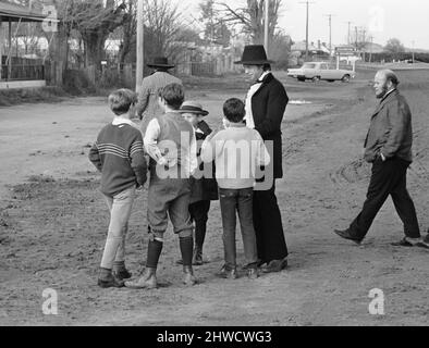 Rolling Stones: Mick Jagger che gioca il ruolo principale nel film Ned Kelly, è circondato da bambini in strada durante una pausa nelle riprese a Bugendore, Australia.Luglio 1969. Foto Stock