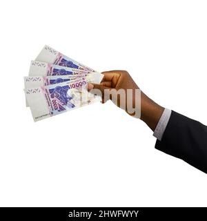 Mano nera con tuta in grado di tenere 3D reso 10000 West African CFA Franc note isolate su sfondo bianco Foto Stock
