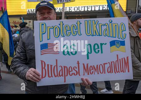 New York, Stati Uniti. 05th Mar 2022. Un manifestante ha un cartello che invita gli Stati Uniti a proteggere l'Ucraina in base al Memorandum di Budapest al raduno 'Stand with Ukraine' a Times Square il 5 marzo 2022 a New York City. Ucraini, ucraini-americani e alleati si sono riuniti per mostrare sostegno per l'Ucraina e protestare contro l'invasione russa Credit: SOPA Images Limited/Alamy Live News Foto Stock