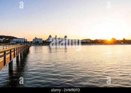 Germania, Mecklenburg-Vorpommern, Binz, costa dell'isola di Rugen al tramonto con Kurhaus Binz sullo sfondo Foto Stock