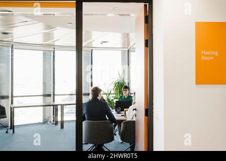 Imprenditore con i colleghi per discutere in sala riunioni Foto Stock