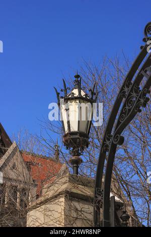 Vecchia lampada da strada gotica medievale in ghisa che si erge nel cortile. Foto Stock