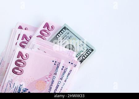 Duecento banconote turche con cento dollari americani e spazio per le copie su sfondo bianco.Vista dall'alto e mezza Foto Stock