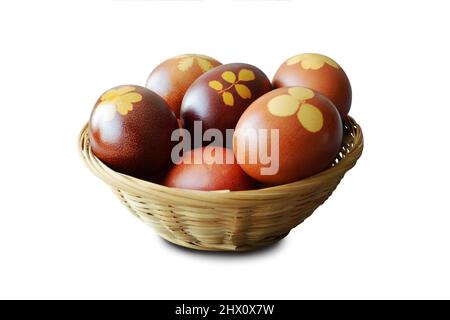 Cestino di Pasqua con uova tinte naturalmente con bucce di cipolla isolate su sfondo bianco Foto Stock