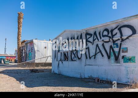 'momma ha sollevato un fuorilegge' graffiti spray dipinta su un edificio, una casa mobile, nell'insediamento di Bombay Beach, California, vicino al Mare di Salton. Foto Stock