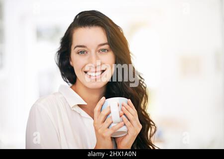 Godendo di una cuca java gioia. Ritratto di una giovane donna felice godendo una tazza di caffè. Foto Stock