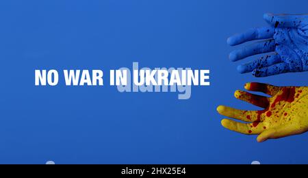 Mani umane nei colori della bandiera Ucraina e con macchie di sangue su sfondo blu. Nessuna guerra in Ucraina Foto Stock